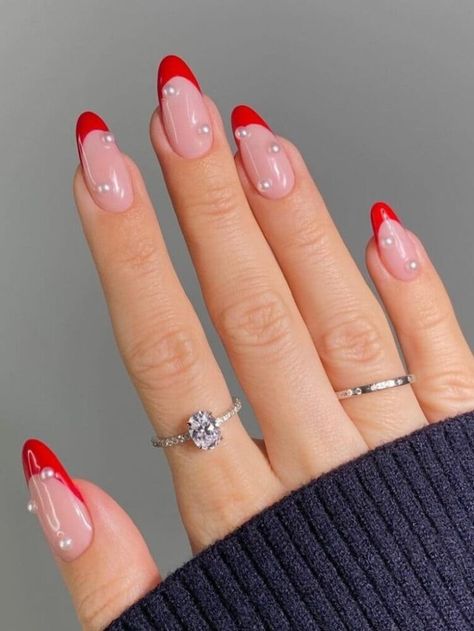 Round-shaped, red French-tip nails with pearls Trendy Xmas Nails, Cute Red French Tip Nails, Christmas French Tip Nails Almond, Christmas Red French Tip Nails, Red French Christmas Nails, Minimalist Red Nails, Red Almond French Tip, Red French Tip Nails Christmas, Red Tip Christmas Nails