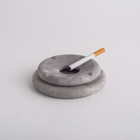 Two-piece ashtray, base and lid hand-carved in marble stone.  It belongs to the Pebbles collection, distinguished and inspired by rounded, risky and modern shapes.  Unique and beautiful. Avoid abrasives and domestic cleaning materials. Use a soft, dry cloth to wipe the surface carefully. Ash Trays Aesthetic, Ceramic Ashtray Handmade, Unique Ashtrays, Ashtray Clay, Stone Ashtray, Ashtray Design, Marble Ashtray, Interior Design Accessories, Pottery Ashtray