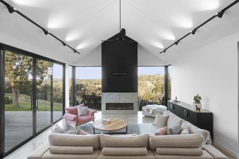 The Axis Track Light employed in a unique style in this Warrandyte home. Rotating the lens head to spread an evenly diffused light across triangular raking ceilings; this elegant technique highlights the unconventional structure of the home while providing functional and contemporary illumination.   What do you think of this technique?  #unioslight #lighting #design #interior Track Lighting Living Room, Sloped Ceiling Lighting, Vaulted Ceiling Ideas, Vaulted Ceiling Lighting, High Ceiling Lighting, Pitched Ceiling, Raked Ceiling, Lounge Lighting, Track Light