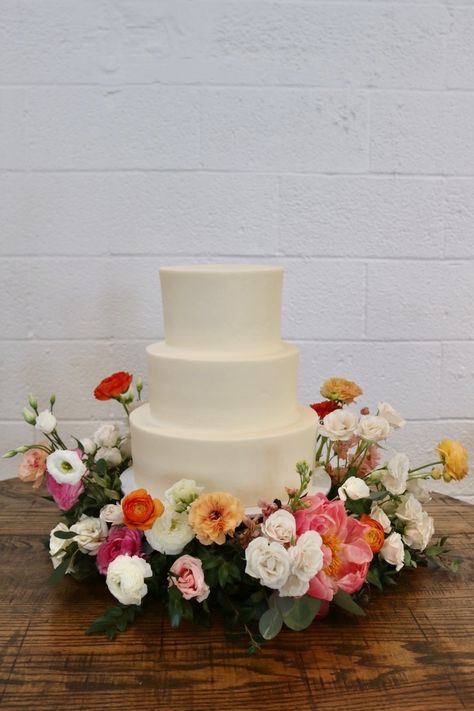 Floral 3 Tier Wedding Cake, Plain White Wedding Cake With Flowers, Cake Surrounded By Flowers, Wedding Cake Surrounded By Flowers, Wedding Cake With Flowers Around Base, Flowers Around Wedding Cake, Cake Table Florals, Simple 3 Tier Wedding Cake, Tres Leches Wedding Cake