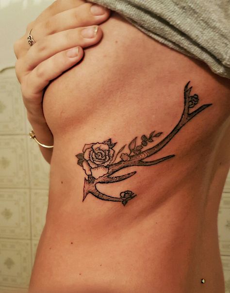 Black and white Deer Antler with single rose rib tattoo- my original design Microdermal lumbar back piercing, green Opal Antler With Roses Tattoo, Antler Rib Tattoo, Deer Antler Tattoo With Flowers, Deer Antler Tattoos, Rose Rib Tattoos, Tattoo On Ribs, Antler Tattoos, Antler Tattoo, Deer Skull Tattoos