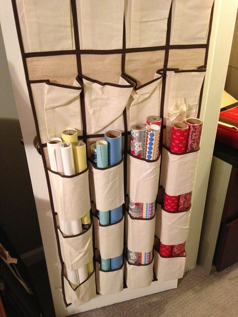 Cut the bottoms of shoe organizer pockets to keep rolls of wrapping paper organized. Organiser Son Dressing, Wrapping Paper Organization, Shoe Caddy, Wrapping Paper Storage, Hanging Shoe Organizer, Holiday Storage, Organisation Hacks, Dollar Store Organizing, Craft Room Storage