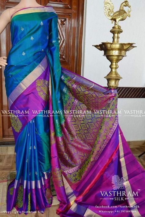 Dual tone peacock blue pure kanchi soft silk saree with zari motifs on all over, zari and purple with green thread woven motifs on border, thread woven pallu. Code: O1018SS150904 Cost:8800 INR Whatsapp: +91 7019277192 Peacock Blue Saree Silk, Peacock Blue Saree, Pakistani Saree, Saree Color Combinations, Silk Saree Blouse Designs Patterns, Latest Silk Sarees, Blouse Works, Gold Haram, Blue Silk Saree