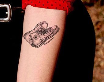 Converse Tattoo, Theatre Tattoo, Tattoo Under Chest, Rose Tattoo On Side, Design Converse, Tattoo Samples, Flower Tattoo On Side, Ribbon Tattoos, Lily Tattoo