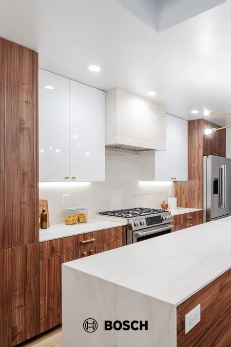 The Bosch fridge and range look at home with the high gloss white and walnut cabinets in this modern kitchen by @markahermogeno. The skylights are a bonus too! Thanks so much for sharing your work. Photo Credit: Neue Focus. Cabinets: NGY Group Inc. Countertops + Skylight: @Dekton_ . Walnut And White Kitchen, White And Walnut Kitchen, Kitchen 2025, Flat Front Cabinets, Bosch Fridge, Walnut Kitchen Cabinets, White Gloss Kitchen, Top Kitchen Cabinets, Organic House