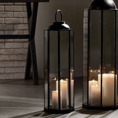 Standing at over tall, the turino lantern is all about drama. a stunning focal point. | Longshore Tides Iron Floor Lantern black/gray 27.25 x 8.5 x 8.5 in | C004147251_487469334 | Wayfair Canada Lantern Fireplace Decor, Floor Lanterns, Rustic Cottage Style, Tall Lanterns, Floor Lantern, Glass Candle Lantern, Floor Candle Holders, Kitchen Island Decor, College Apartment Decor