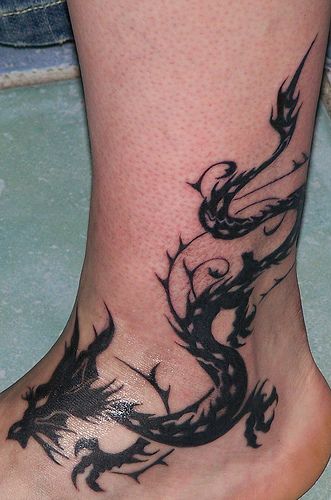 Ankle tattoos dragons | Tribal Tattoo Design: Black Dragon Tribal Tattoo: on Foot Dragon Ankle Tattoo, Dragon And Tiger Tattoo, Ankle Tattoo Men, Stammestattoo Designs, Traditional Heart Tattoos, Around Arm Tattoo, Tatuagem Masculina Pequena, Waist Tattoos, Ankle Tattoo Designs