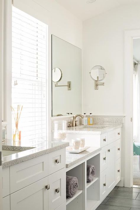 Beautifully designed white bathroom boasts his and her white washstands adorning polished nickel square knobs and speckled quartz countertops fitted with satin nickel faucets placed beneath frameless vanity mirrors mounted on either side of a window dressed in white blinds. Corner Bathroom, Contemporary Bathroom Designs, Bad Inspiration, Medicine Cabinets, White Vanity, Basement Bathroom, Upstairs Bathrooms, Bathroom Redo, Girls Bathroom