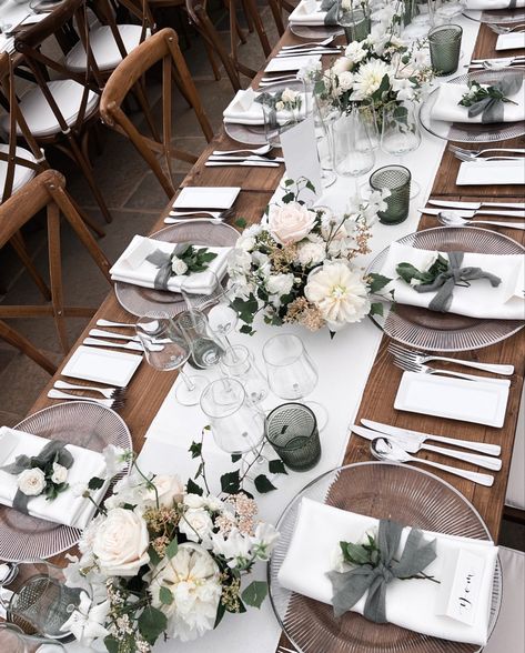 White wedding flowers in white ceramic bowls.