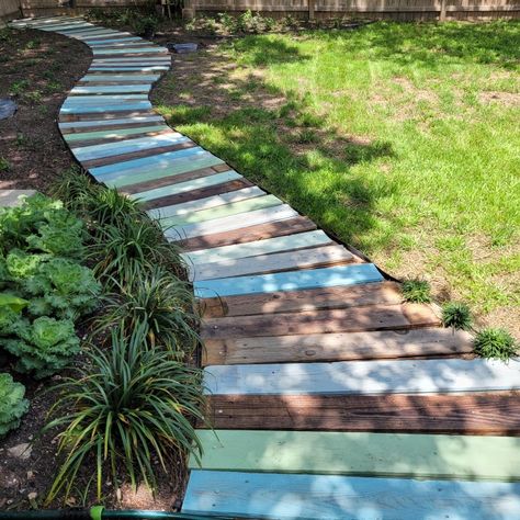 I created this path in my backyard from old 6' wood privacy fence pickets. Creating Paths In Woods, Wood Garden Paths And Walkways, Diy Boardwalk Path, Repurpose Deck Boards, Old Fence Wood Projects, Backyard Boardwalk, Pallet Path, Wood Path, Wood Privacy Fence