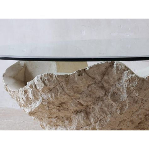 This Post-Modern coffee or side table from Magnussen Ponte, from the 1980s, has a special design in the shape of a shell or oyster with a pearl in the middle.  The table is made of Mactan stone, also known as Fossil Stone, with a rough edge motif. The material has an appearance similar to travertine, but is lighter in weight. The round glass plate is facet cut, which contributes to the refined finish.  Mactan stone is a natural stone that, despite its heavy and monumental appearance, is relative Fossil Stone Coffee Table, Shell Coffee Table, Wabi Sabi Coffee Table, Triangle Coffee Table, Stone Coffee Table, Brass Coffee Table, Glass Plate, Post Modern, Coffee Table Square