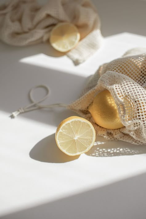 Mesh produce bags with lemons in sunlight. Minimal brand styling and photography for wellness and lifestyle boutique. Yellow and cream color palette. lemons, food styling, minimal food photography, light and shadows, mesh produce bags Food Photography Fruit, Color Mood Board, Sunlight Photography, Yellow Photography, Healthy Wellness, Minimal Photo, Minimal Photography, Text Logo Design, Object Photography