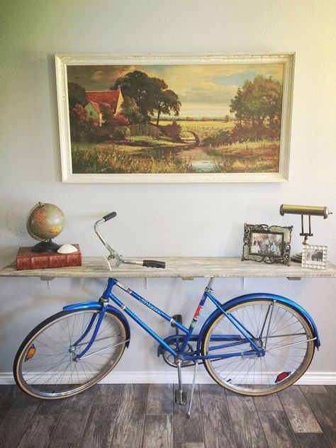 When I bought my vintage bike years ago, I knew it was extra special... But having moved and downsized, she needed to find a home where she didn't collect dust. When no one wanted to buy her, my vision of making a credenza was born! We used a rustic room divider that I no longer used. My husband was the best at recreating my vision and he installed brackets to secure the wood to the wall (I wanted it to appear as though the table was being held up by the bike) And the finished lo… Credenza Diy, Bjj Gym, Reused Furniture, Bike Decor, Bicycle Diy, Vintage Milk Can, Sweet Charity, Old Bicycle, Rustic Room