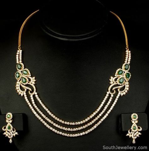 Stunning 3 row diamond string necklace studded with emeralds and complemented by matching earrings. Gold weight 63 grams Price: Rs. 12,32,400.00 For details contact: info@vummidi.com Related PostsBridal Polki Diamond NecklaceDazzling Diamond NecklaceDiamond Ruby JhumkasClassy Diamond NecklaceDiamond Necklace and EarringsSneha in Bridal Jewellery 22 Carat Gold Jewellery, Beautiful Diamond Necklace, Bridal Jewellery Design, Diamond Necklace Designs, Bridal Necklace Set, Diamond Necklace Set, Diamond Solitaire Necklace, Diamond Jewelry Designs, Gold Jewelry Simple