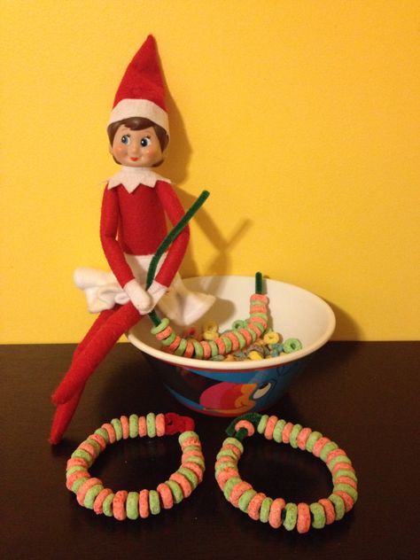 Jingle Bell our Elf on the Shelf making bracelets from red and green fruit loops! (Day 26). Elf On The Shelf Bracelets, Elf Magic, Fruit Loops, Awesome Elf On The Shelf Ideas, Green Fruit, Jingle Bells, Elf On The Shelf, Bracelet Making, Elf