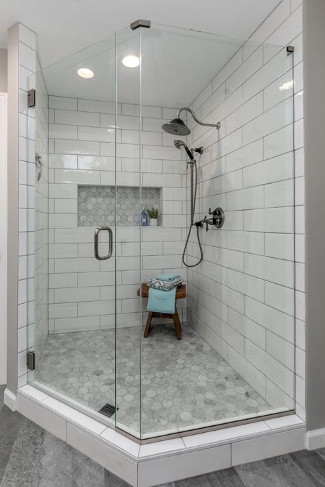 An outdated tub/shower combo was taken away to make room for this large corner shower, complete with large format subway tiles and textured accents. L Shaped Tub Shower Layout, Large Format Subway Tile Bathroom, Large Corner Shower Ideas, Corner Walk In Shower Ideas, Corner Shower Remodel, Corner Shower Tile, Corner Tub Shower Combo, Corner Shower Ideas, Corner Tub Shower