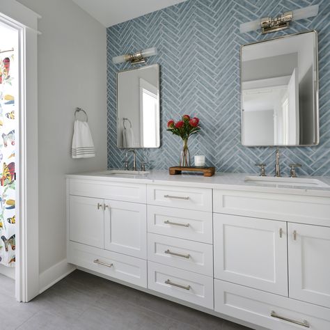 Adding a touch of whimsy while keeping things elevated and fresh, our blue herringbone tile with contrasting white grout gets top marks! Adding in simply touches of decor that highlight other colors in the space is a great way to cross-polinate those tones and make the space feel cohesive! Blue Herringbone Tile, Herringbone Bathroom, Burnt Orange Flowers, White Grout, Colorful Shower Curtain, Top Marks, Herringbone Tile, Decor Elements, Herringbone Pattern