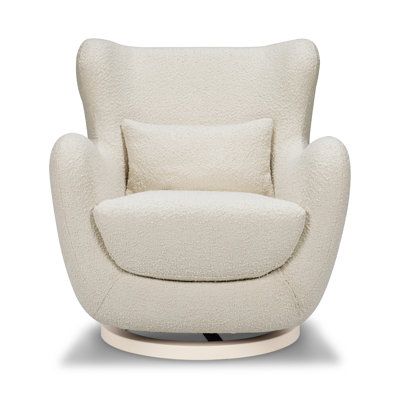 The Solstice Swivel Glider has a modern sculptural silhouette with a distinctive curved back and armrests. This glider boasts a one-of-a-kind slope design, creating a stunning visual element in any space. Crafted with precision and care, this glider is made with the finest materials. The rich boucle fabric is soft to the touch, inviting you to snuggle up with your little one. Add a touch of modern elegance to your home with the Nursery Works Solstice Swivel Glider. Upholstery Color: Ivory Nurser Nursery Glider Chair, Slope Design, Nursery Rocker, Swivel Rocker Chair, Nursery Glider, Glider Rocker, Rocker Chairs, Nursery Chair, Glider Chair