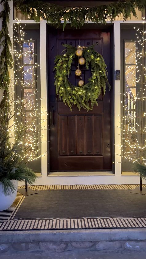 Wreath Above Garage Door, Christmas Decor Frontyard, Christmas Front Porch Double Doors, Outdoor Christmas Wreaths On Garage Lights, Outdoor Christmas Inspiration, Minimalist Christmas Front Porch, Long Porch Christmas Decor, Garland On House Exterior, Wreath On Garage