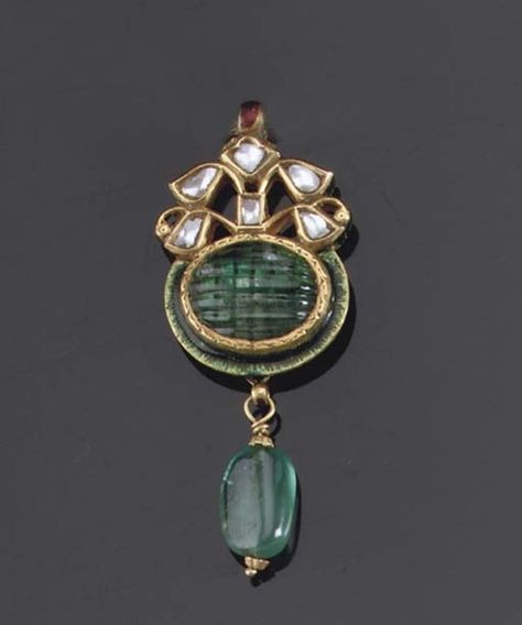 AN INDIAN GEM-SET AND ENAMEL PENDANT   The oval carved emerald with foliate surmount supporting an emerald drop on a woven chain Indian Gold Earrings Designs, Indian Gold Earrings, Mughal Jewelry, Carved Emerald, Pendant Sets, Heritage Jewellery, Antique Jewelry Indian, Wedding Jewellery Collection, Diamond Jewelry Designs