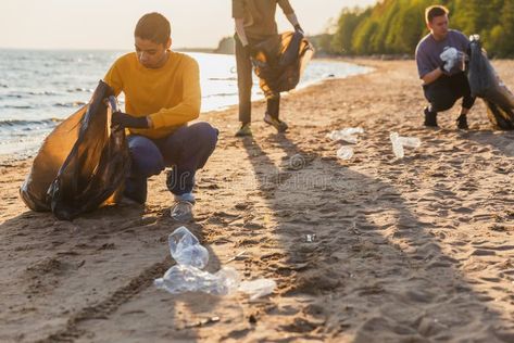 Earth day. Volunteers activists team collects garbage cleaning of beach coastal zone. Woman mans puts plastic trash in royalty free stock photograph Real Pictures, Earth Day, Stock Images, Water