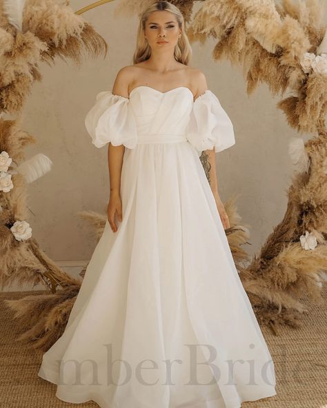 Experience enchanting elegance with this puffy sleeves fairy organza modest wedding dress, designed to make you feel like a fairytale bride. The romantic A-line silhouette adds a timeless charm to your special day. 🌸 . . . . #ModestWeddingDress #SimpleWeddingDress #PuffySleevesBridalDress #ShortBridalDress #RomanticWeddingGown #MinimalistWeddingGown #BridalDress #WeddingGown #FairyDress #ALineWeddingDress #OffTheShoulderDress #BridalFashion #WeddingStyle #BridalInspiration #BridalLook #Wedd... Puffy Sleeve Wedding Dress, Wedding Dress Puffy, Corset Silhouette, Detachable Puff Sleeves, Wedding Dress Casual, Off Shoulder Puff Sleeve, Wedding Dress Strapless, Organza Wedding Dress, Organza Wedding