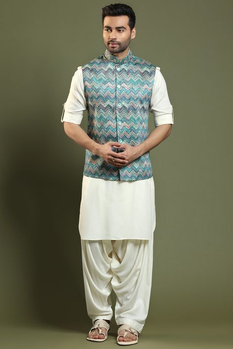 Featuring a cream kurta in blended silk base with a roll-up placket and a mandarin collar. It is paired with matching cowl salwar pants having pleats and a pale turquoise bandhani printed bundi jacket with a chevron design.  FIT: True to size. COMPOSITION: Blended silk. CARE: Dry clean only. Bandhani Jacket, Salwar Pants, Mens Kurta, Pale Turquoise, Nehru Jacket, Kurta Pajama, Nehru Jackets, Chevron Design, Indian Fashion Designers