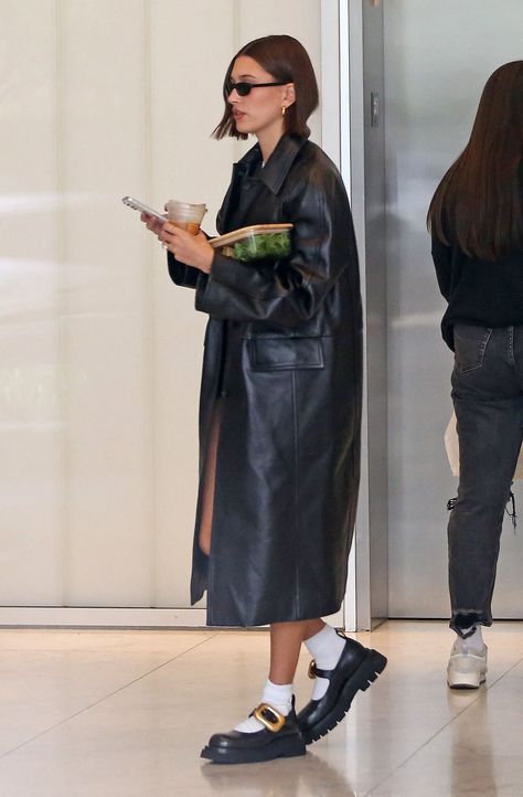 Hailey Bieber Wears the World’s Boldest Mary Janes | Vogue Mary Jane Outfit, Long Black Trench Coat, Hayley Bieber, Whimsical Shoes, Hailey Bieber Style, Hailey Baldwin Style, Black Trench Coat, Bottega Veneta Shoes, French Girl Chic