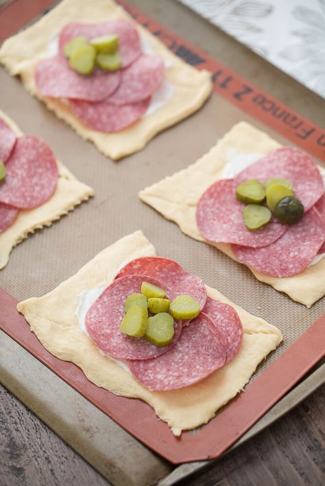 Bundles made with crescent dough are filled with cream cheese, herbs, salami and pickles. A surprising good break from the ordinary! Cream Cheese Pickles, Salami Cream Cheese, Salami Appetizer, Salami Rolls, Wrapped Pickles, Salami Recipes, Cheese Pickles, Ham Wraps, Homemade Ham