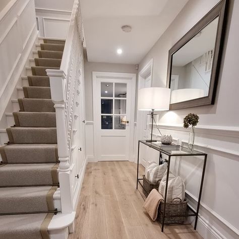 Hallway with light painted panelling and oak flooring. Black And White Entryway, Long Narrow Hallway Ideas, Painted Panelling, Entryway Designs, New England Style Homes, White Entryway, 1960s House, Narrow Hallway Ideas, House Staircase