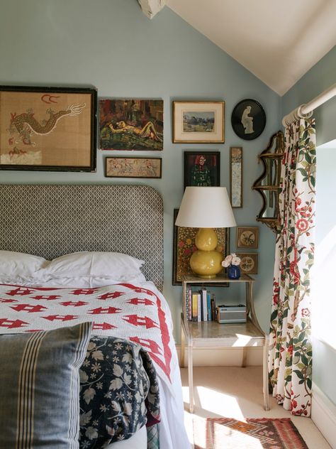 An artist's house in the Cotswolds layered with bold colours and collected pieces | House & Garden House And Garden Bedroom Ideas, Cotswold Bedroom Ideas, Collected Interior Design, Pale Blue Walls Bedroom, Maximalist Guest Bedroom, Mix And Match Bedding Ideas, Blue Walls Bedroom Ideas, Simple Eclectic Home, Bedroom English Cottage