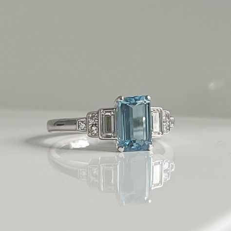 Sally and Paul had designed their engagement and wedding rings with Rosie at Petra Jewellery. Sally had used the diamonds from some sentimental inherited pieces to make her engagement ring but had a beautiful emerald cut aquamarine that was too beautiful to put back in her jewellery box. So she and Paul came back in to see what to do with it… As well as the aquamarine, there were a few small round diamonds leftover. Sally knew she wanted something to complement her engagement ring but stil... Engagement And Wedding Rings, Emerald Cut, Aquamarine, Round Diamonds, Jewelry Box, Engagement Ring, Emerald, Wedding Rings, Diamonds