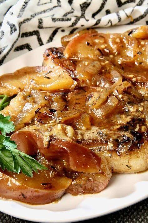 Pork Chops with Apples and Onions | "This is by far one of the best recipes I've ever found! Succulent pork chops with a phenomenal spice rub cooked in a sweet sauce with onions and apples. A perfect autumn dish, but tasty all year-round!" #dinnerideas #dinnerrecipes #familydinnerideas #pork #porkrecipes Skillet Pork Chops With Apples And Onions, Baked Apples And Porkchops, Oven Baked Pork Chops With Apples And Onions, Bone In Pork Chops With Apples, Apple Compote Recipe Pork Chops, Pork Chops With Apples And Onions, Pork Chops And Apples Recipes, Pork Chops Apples And Onions, Pork With Apples And Onions