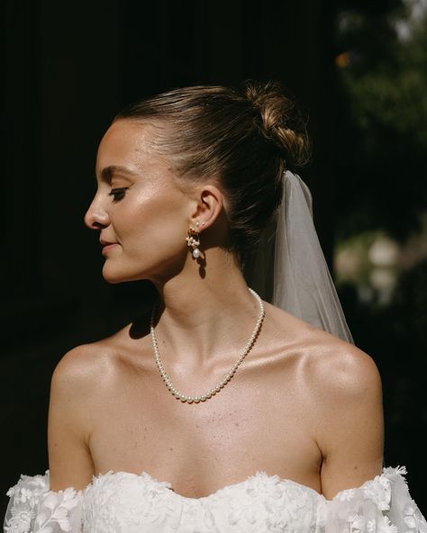 We absolutely adore this bridal look that Adrienne brought together by blending over the top romantic textures with simple and elegant beauty choices. Her sleek high bun, with the veil placed underneath, allowed her to be the center of focus and still made room for playfulness with the added layers of fabric From her embroidered matching puff sleeves to the sheer skirt she wore over the dress for ceremony - her styling was elite. Her glowy skin caught the light perfectly in the pockets of s... Luxury Romantic Dress With Sheer Back, Dress For Ceremony, Luxury Romantic Bodice With Sheer Details, Sleek High Bun, Veil With Pearl Edge, Luxury Sheer Elegant Veil, Sheer Veil Over Face, Elegant Beauty, High Bun