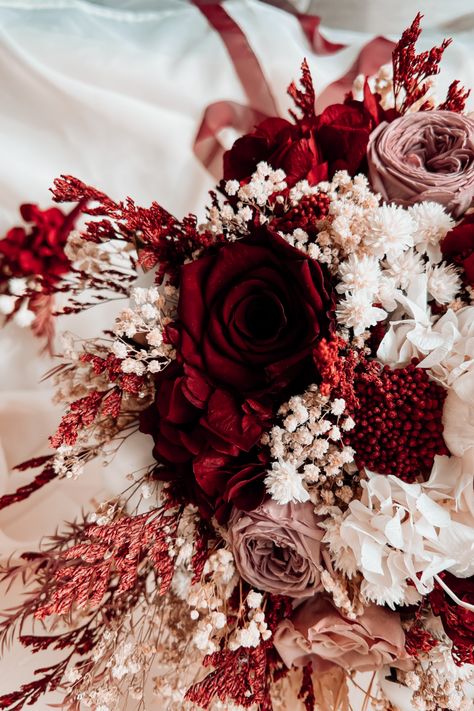 Celebrate love with a Burgundy Bridal Bouquet that embraces Marsala elegance. This Dried Flower marvel exudes Boho charm, featuring preserved roses, baby's breath, and more. It's a unique touch for weddings, radiating sentiment and best wishes. ⭐ Flowers Used: Shola, Preserved Roses, Baby's Breath, Hydrangea, Ozhotamnus, Tea Tree, Cephalaria. Make your presence memorable on this special day.