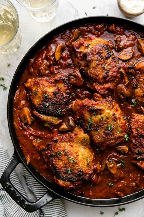 This easy Chicken Cacciatore recipe is slowly simmered Italian comfort food! Rich, flavor-forward chicken thighs become fall-apart tender as they slowly simmer with peppers, onions, & mushrooms in a cacciatore sauce made with tomatoes & wine. Serve over polenta, or with rice, potatoes, or pasta! A one-skillet meal – stovetop, oven-braised, slow cooker, & Instant Pot directions provided. Make ahead- & freezer-friendly! #chickencacciatore #italianrecipes #skilletmeals #comfortfood #dinnerideas Cacciatore Sauce, Chicken Cacciatore Easy, Chicken Puttanesca, Puttanesca Recipe, Puttanesca Sauce, Cacciatore Recipes, Chicken Cacciatore Recipe, Italian Comfort Food, Fishing Cabin