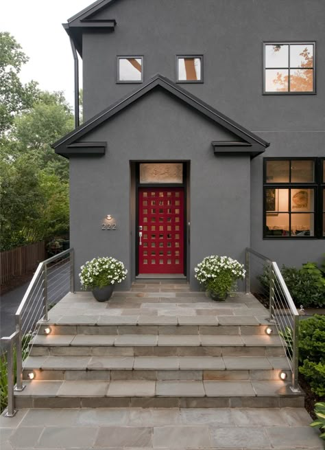 This home’s clean lines and crisp design speak for themselves! Home highlights include flagstone, stainless steel, a modern color palette and one strong red front door!   Photography by Maxwell MacKenzie #welcome  #modern #luxurydesign Red Entry Door, House With Black Trim, Red Door House, Home Remodeling Exterior, Gray House Exterior, Modern Lodge, Home Art Studio, Gray House, House Paint Colors