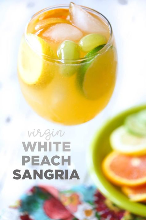 Perfect for summer parties, brunches, Mother's Day, or just a girls' night in, this Virgin White Peach Sangria is your perfect warm-weather party drink! #OurBestBites #Mocktail #Sangria #SangriaRecipes #PartyDrink #babyshower #nonalcoholic #drinks #brunch Mocktail Sangria, Detox Night Drink, Drink Mocktail, Virgin Sangria, Weather Party, White Peach Sangria, Nonalcoholic Drinks, Virgin Drinks, Our Best Bites