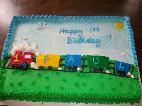 This cake was a half-sheet cake that was half yellow and half chocolate.  I frosted it with Extra Special Buttercream and the train and sun were mmf.  A smash cake matched the train theme for the day. Train Sheet Cake, Train Bday Cake, Simple Train Birthday Cake, Easy Diy Train Cake, Thomas The Train Sheet Cake, Half Sheet Cake, Train Birthday Cake, Rectangle Cake, 2nd Birthday Boys