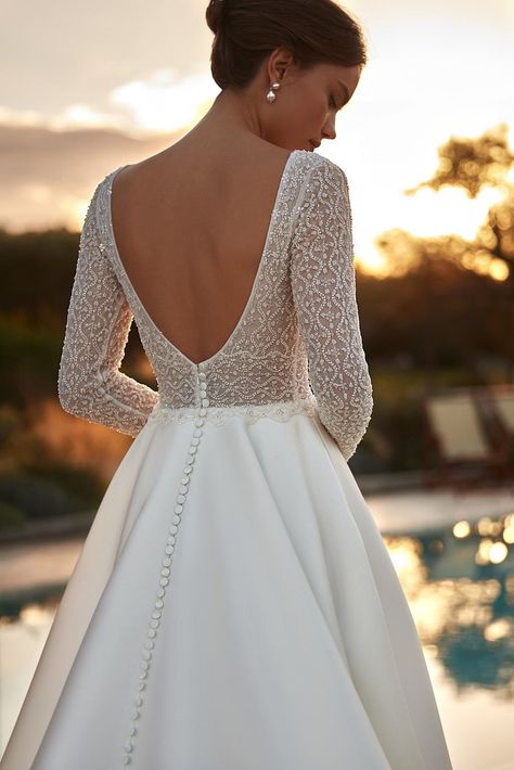 Experience the epitome of bridal elegance with our modern long sleeve wedding gown. Crafted to exude sophistication and grace, this dress features an intricately beaded corset that highlights your waist with stunning finesse. The luxurious lace sleeves and deep V-back are designed to reveal just the right amount of ski Long Sleeve Wedding Gown, Corset Plus Size, Custom Design Dress, Beaded Corset, Long Bridal Gown, Long Sleeve Wedding Gowns, Classic Bride, Timeless Wedding Dress, Wedding Gowns With Sleeves