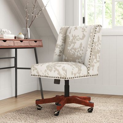 This task chair is versatile enough to glide across multiple floor types with its five caster wheels, and it features a breezy cow spot pattern for some coastal farmhouse charm. It's founded atop a wooden pedestal base, and the seat and back are wrapped in faux fur upholstery made from a polyester blend. This computer chair is also foam-filled to give you enough support as you go from task to task, while subtly winged sides and nailhead trim round out this modern look. It also showcases a height Cow Office Chair, Coastal Office, Swivel Desk Chair, Wooden Pedestal, Floor Types, Swivel Desk, Dining Room Chairs Upholstered, Swivel Chair Desk, Cow Spots