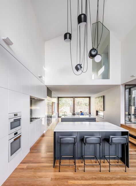 Iron Maiden House,© Murray Fredericks Double Height Kitchen, Engineered Quartz, Double Height, Paper Lampshade, Australian Homes, Modern Pendant Light, Iron Maiden, Modern Pendant, White Cabinets