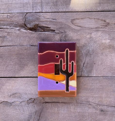 These light switch plate covers add a little touch of functional art to your home decor, hand painted using a variety of ceramic, lead-free, glazes. These are made in Tucson, Arizona. You can choose this design in over 20 standard and hard to find combination configurations. Fired in a kiln at over 1800 degrees, these covers are waterproof and fade resistant; clean with a damp cloth. Each cover comes with nylon screws for easy installation. The backs of the plates are concave, indented for easy Outlet Painting Ideas Easy, Painting Outlet Covers, Outlet Painting Ideas, Painting Outlets, Painted Outlets, Light Switch Art, Light Switch Covers Diy, Wall Switch Plates, Ceramic Light