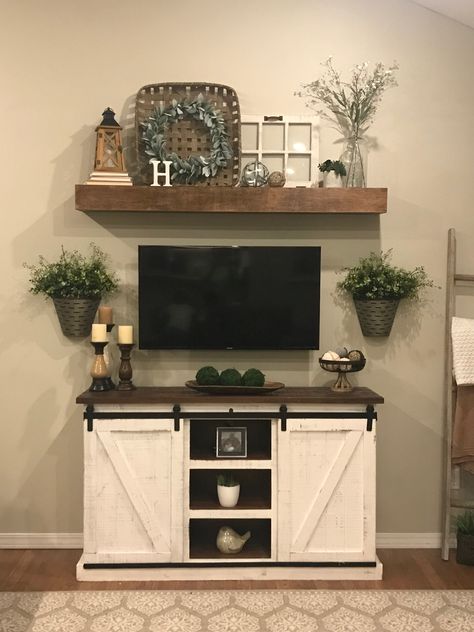 Farmhouse Above Tv Decor, Rustic Shelves Over Tv, Western Tv Wall Ideas, Western Living Room Shelf Decor, Farmhouse Decor Around Tv On Wall, Clock Above Tv, Farmhouse Shelf Under Tv On Wall, Tv Entertainment Wall Rustic, Home Decor Tv Stand