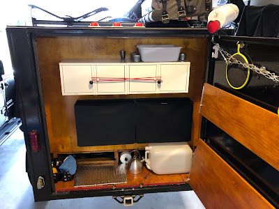 Ch. 4: Kitchen work area and Interior Cabin of the SquareDrop Camper Squaredrop Camper, Small Cargo Trailers, Kitchen Work Area, Coleman Stove, Fish Cleaning Table, Interior Cabin, Door Jam, Plywood Walls, Trailer Interior