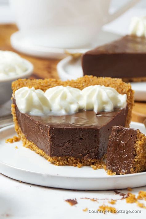 Evaporated milk chocolate pie recipe is what dessert dreams are made of! A silky-smooth chocolate pudding is tucked inside a buttery graham cracker crust. This chocolate satin pie recipe will be a hit with your family! The crispy crust holds the rich chocolate pudding filling. With 10 minutes prep, it’s the kind of pie you want to keep in the back of your mind year-round. That makes it handy for birthdays, the crazy holiday rush, and literally any occasion in between. | CountryHillCottage.com Chocolate Pie Recipe With Graham Cracker Crust, Chocolate Pie With Sweetened Condensed Milk, Chocolate Impossible Pie, Chocolate Pudding Pie With Sweetened Condensed Milk, Chocolate Cream Pie Graham Cracker Crust, Chocolate Pie With Graham Cracker Crust, Graham Cracker Pies, Milk Chocolate Pie Recipe, Chocolate Fudge Pie Recipe