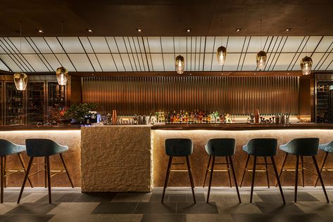 A solid walnut top and pink marble front form the bar; behind it, panels of copper and oxidized steel rotate to create a rippling effect. Sushi Bar Design, Japanese Restaurant Interior, Sake Bar, Japanese Bar, Traditional Dining Chairs, Fusion Restaurant, Western Furniture, Restaurant Lighting, Restaurant Lounge