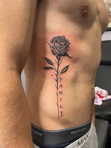 Rub Tattoos Men, Tattoo Ideas For Men Ribcage, Rose Tattoo Men Back, Men’s Neck Tattoos Side, Men’s Side Rib Tattoo, Side Tattoos Men Ribs Guys, Rose Side Rib Tattoo, Back Side Tattoo For Men, Rose Tattoo Men Ribs