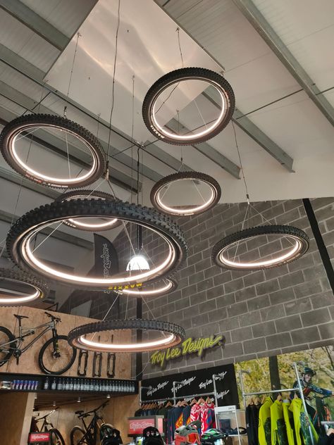 BESPOKE LIGHTS FIT FOR A NEW E BIKE SHOWROOM Bike Showroom, Garage Lights, Bike Room, Bicycle Store, Bicycle Decor, Kitchen Design Layout, Pool Outdoor, Bicycle Shop, Wheel Chandelier