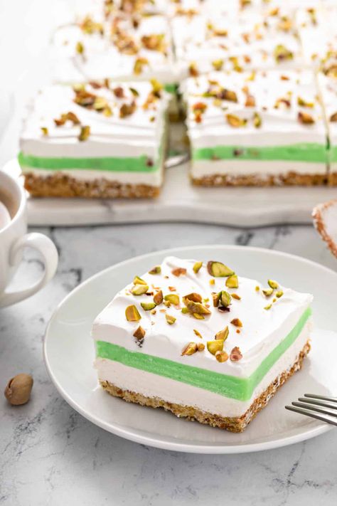 Cool, creamy, and full of nutty pistachio flavor, this Layered Pistachio Pudding Dessert is both delicious and beautiful! This is one simple dessert that your family will ask for again and again. Pistachio Pudding Dessert, Pistachio Recipes Desserts, Pistachio Pudding Cake, Pistachio Dessert Pudding, Pudding Desserts Recipes, Pistachio Dessert, Pistachio Recipes, Layered Dessert, Pudding Dessert